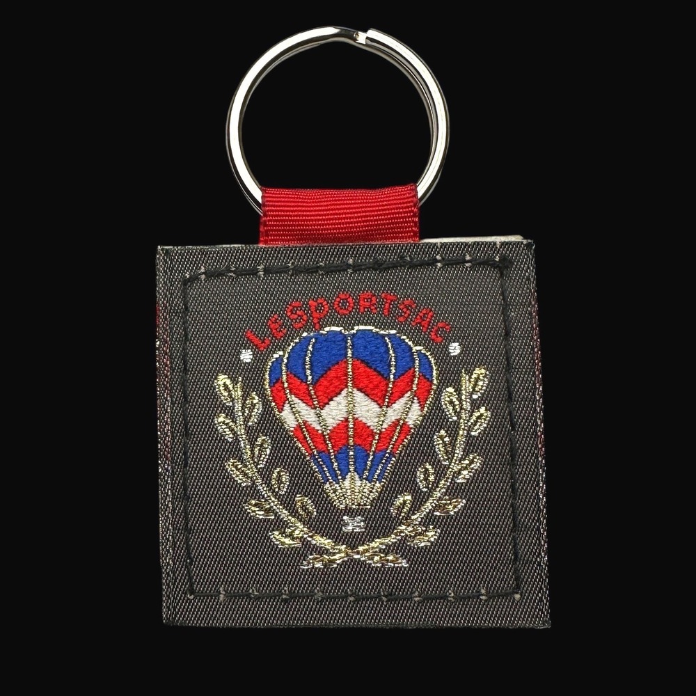 LeSportsac Hot Air Balloon Embroidered Keychain Grey Red Blue Laurel Wreath